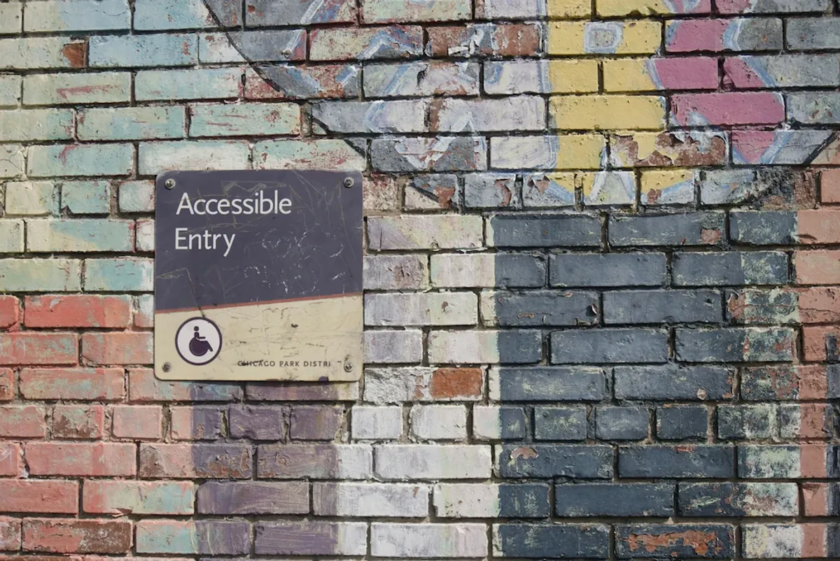 A multicolor wall with the sign Accessible Entry